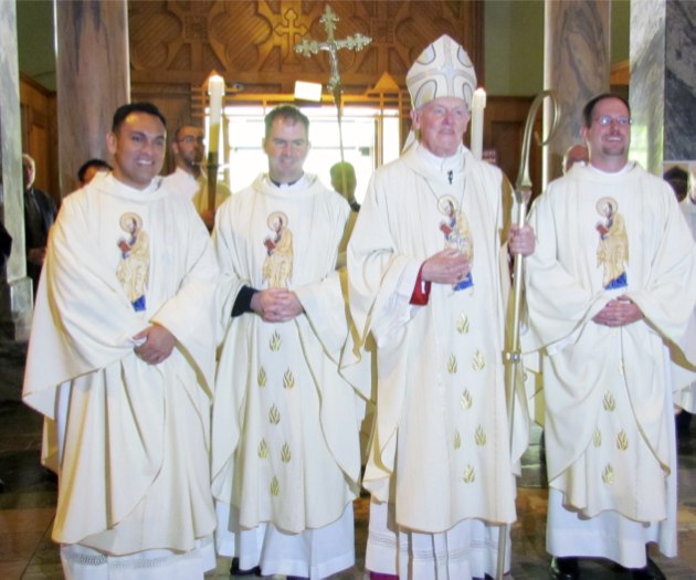 Newly ordained Father Rene I. Constanza, CSP (left), Father Thomas C. Gibbons, CSP, and Father Richard R. Andre, CSP (right) stand beside Bishop Walter Hurley of Grand Rapids, Mich., after the ordination Mass May 19. (Photo: Stefani Manowski)